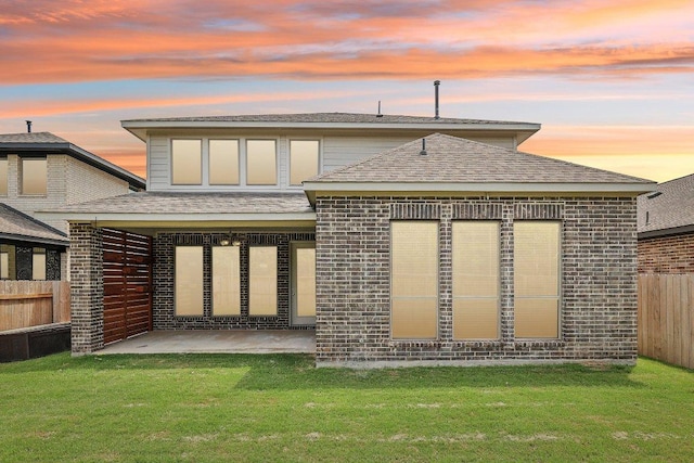 125 Bauer Loop, Liberty Hill, TX 78642 - rear view of house with a patio, brick siding, and roof with shingles