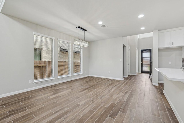 125 Bauer Loop, Liberty Hill, TX 78642 - unfurnished dining area with wood finished floors and recessed lighting