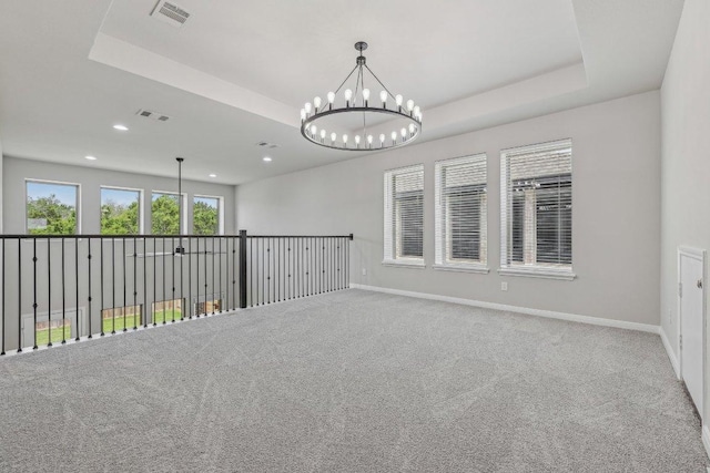 125 Bauer Loop, Liberty Hill, TX 78642 - unfurnished room with a chandelier, a tray ceiling, recessed lighting, and carpet floors