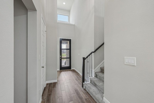 125 Bauer Loop, Liberty Hill, TX 78642 - entrance foyer with dark wood finished floors, stairway, and a towering ceiling