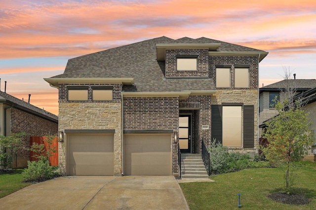 125 Bauer Loop, Liberty Hill, TX 78642 - view of front of home featuring concrete driveway, brick siding, roof with shingles, an attached garage, and a lawn