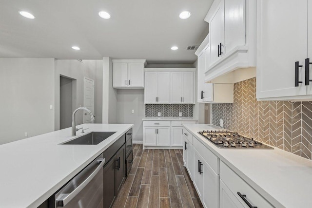 125 Bauer Loop, Liberty Hill, TX 78642 - kitchen with appliances with stainless steel finishes, light countertops, dark wood-style flooring, white cabinets, and recessed lighting