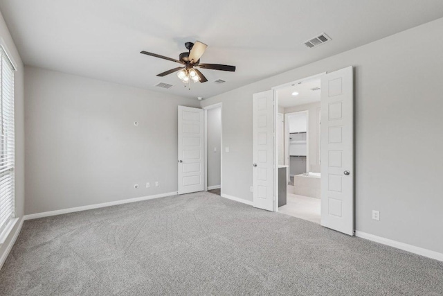 125 Bauer Loop, Liberty Hill, TX 78642 - unfurnished bedroom with carpet floors, a walk in closet, and ceiling fan