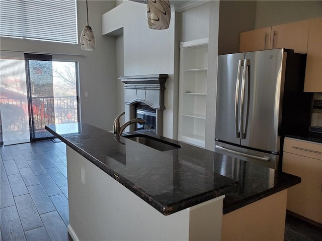 11203 Ranch Road 2222nd Rd Unit 901, Austin, TX 78730 - kitchen featuring freestanding refrigerator, a sink, pendant lighting, built in shelves, and a kitchen island with sink