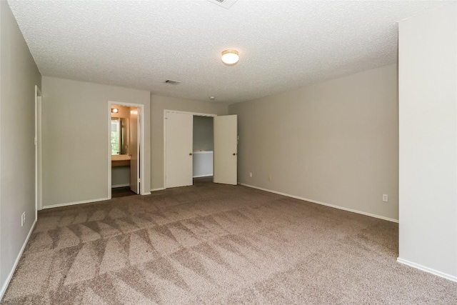 501 Thicket Ln, Kyle, TX 78640 - unfurnished bedroom featuring carpet flooring, baseboards, and a textured ceiling