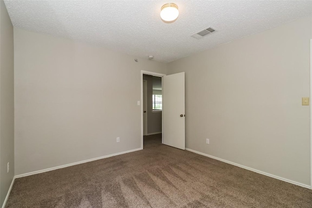 501 Thicket Ln, Kyle, TX 78640 - spare room featuring carpet, a textured ceiling, and baseboards
