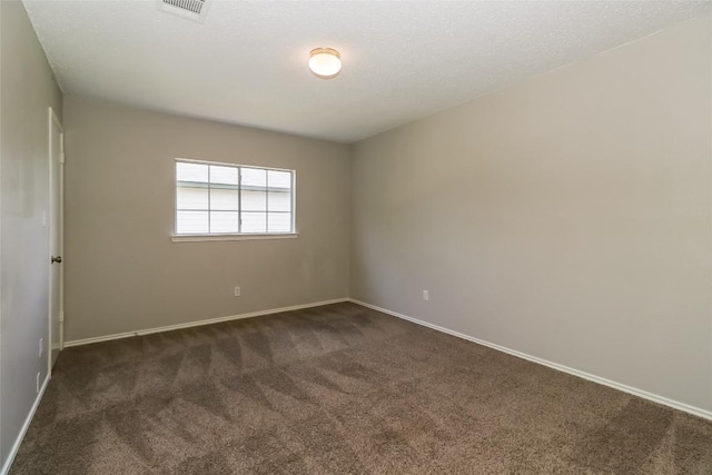 501 Thicket Ln, Kyle, TX 78640 - spare room with dark colored carpet and baseboards