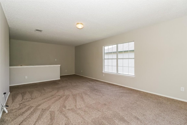 501 Thicket Ln, Kyle, TX 78640 - spare room with carpet flooring, a textured ceiling, and baseboards