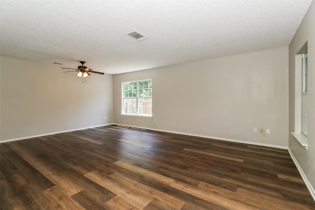 501 Thicket Ln, Kyle, TX 78640 - spare room with ceiling fan, dark wood-style floors, and a textured ceiling