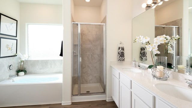 4104 Rushing Ranch Ln, Georgetown, TX 78628 - full bath featuring a shower stall, wood finished floors, a bath, and double vanity