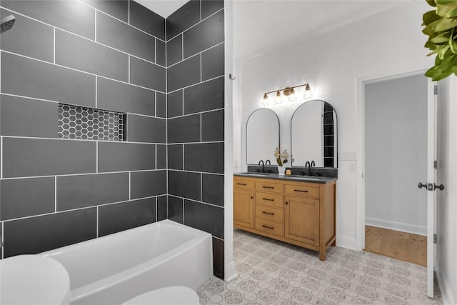 776 Butcher St, New Braunfels, TX 78130 - bathroom featuring a bathtub, double vanity, baseboards, and toilet