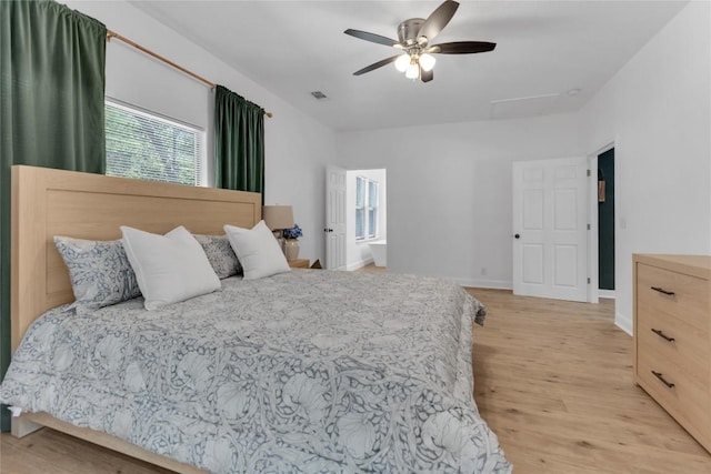 776 Butcher St, New Braunfels, TX 78130 - bedroom featuring light wood-style floors, attic access, a ceiling fan, and baseboards