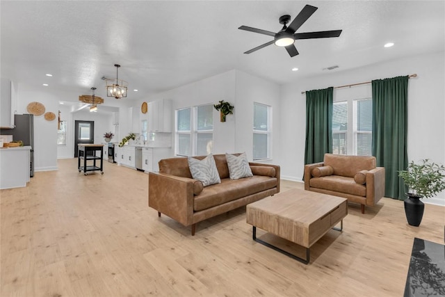 776 Butcher St, New Braunfels, TX 78130 - living room featuring light wood-type flooring, a ceiling fan, recessed lighting, a chandelier, and baseboards