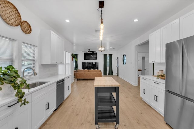 776 Butcher St, New Braunfels, TX 78130 - kitchen featuring stainless steel appliances, a sink, light countertops, white cabinetry, and recessed lighting