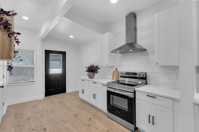 776 Butcher St, New Braunfels, TX 78130 - kitchen with stainless steel range with electric stovetop, extractor fan, light countertops, white cabinets, and recessed lighting