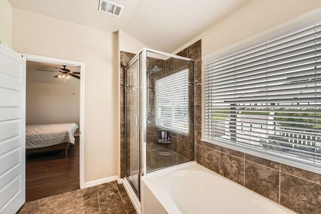 134 Sassafras St, Hutto, TX 78634 - ensuite bathroom featuring a stall shower, a garden tub, ceiling fan, and baseboards