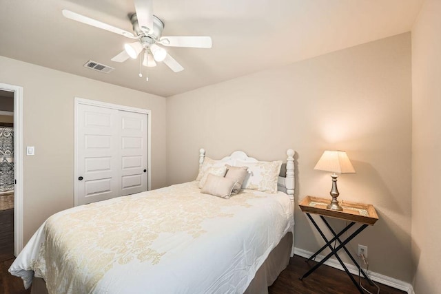 134 Sassafras St, Hutto, TX 78634 - bedroom featuring dark wood-style flooring, baseboards, a closet, and a ceiling fan