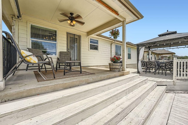 134 Sassafras St, Hutto, TX 78634 - wooden terrace with a gazebo, ceiling fan, and outdoor dining area