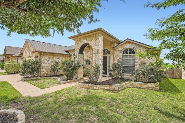 134 Sassafras St, Hutto, TX 78634 - view of front facade with stone siding and a garage