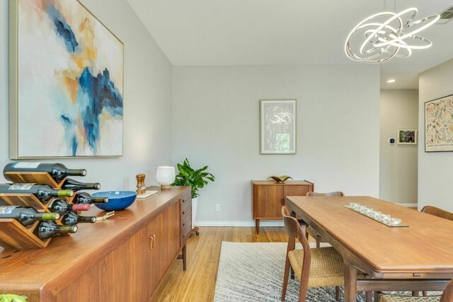 1125 Byers Ln, Austin, TX 78753 - dining area with light wood-style floors, a chandelier, baseboards, and recessed lighting