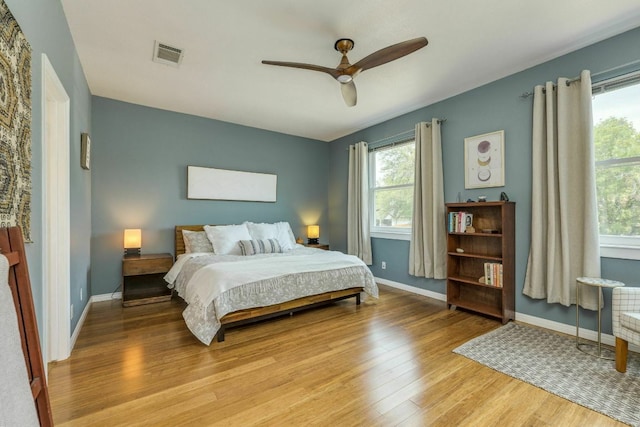 1125 Byers Ln, Austin, TX 78753 - bedroom featuring light wood-style flooring, baseboards, and ceiling fan