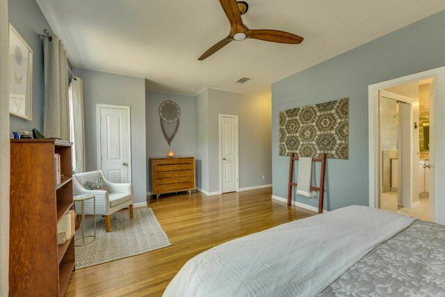 1125 Byers Ln, Austin, TX 78753 - bedroom with wood finished floors, baseboards, a ceiling fan, and ensuite bath