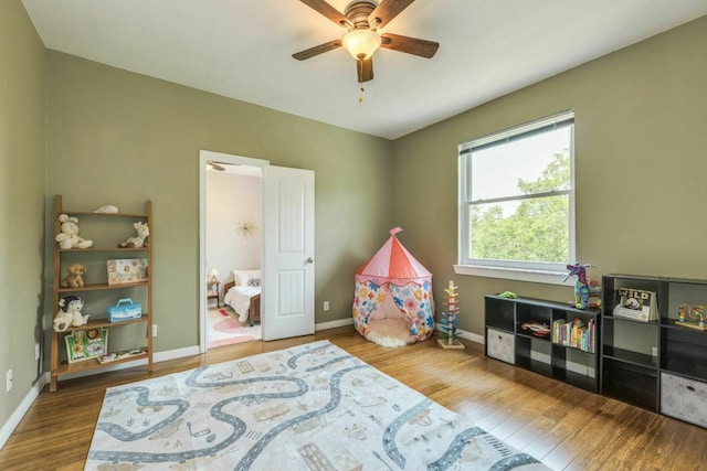 1125 Byers Ln, Austin, TX 78753 - recreation room featuring wood finished floors, a ceiling fan, and baseboards