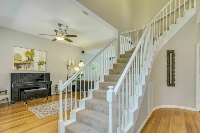 1125 Byers Ln, Austin, TX 78753 - staircase with wood finished floors, ceiling fan, and baseboards