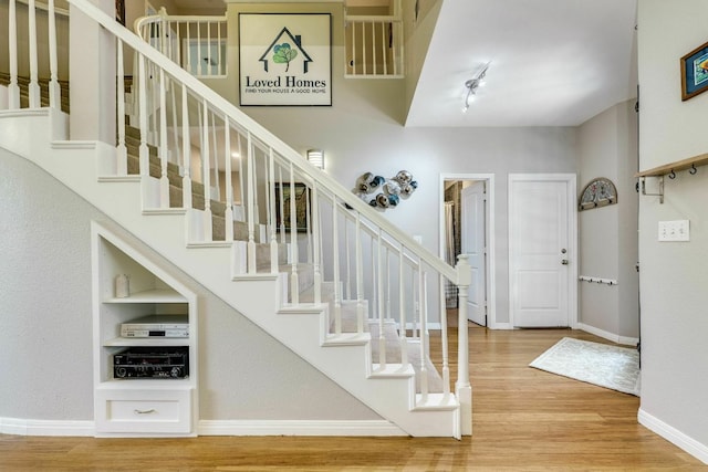1125 Byers Ln, Austin, TX 78753 - entryway featuring wood finished floors, stairway, baseboards, and rail lighting