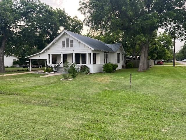 200 N Walton St, Granger, TX 76530 - view of front facade featuring a porch and a front lawn