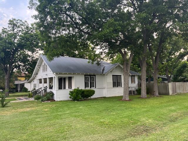 200 N Walton St, Granger, TX 76530 - view of side of home with a metal roof