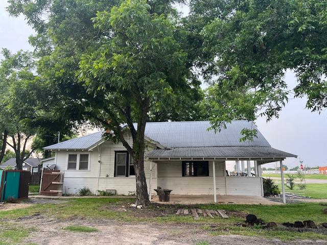 200 N Walton St, Granger, TX 76530 - view of front of house with a porch, a metal roof, and a gate
