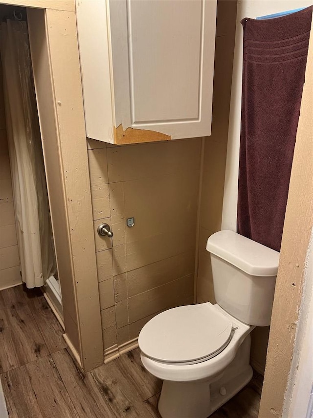 200 N Walton St, Granger, TX 76530 - bathroom with wood finished floors and curtained shower