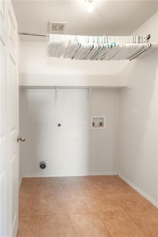 913 Cindy Ln, Leander, TX 78641 - washroom featuring washer hookup, hookup for a gas dryer, hookup for an electric dryer, light tile patterned flooring, and baseboards