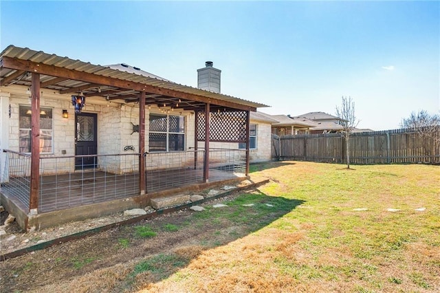 913 Cindy Ln, Leander, TX 78641 - back of house featuring a chimney and stone siding