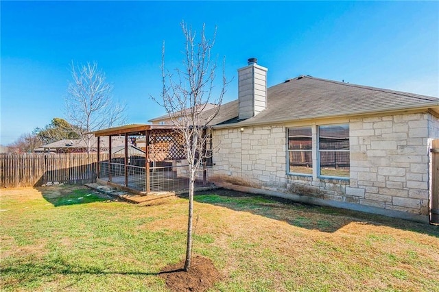 913 Cindy Ln, Leander, TX 78641 - back of house featuring stone siding and a chimney