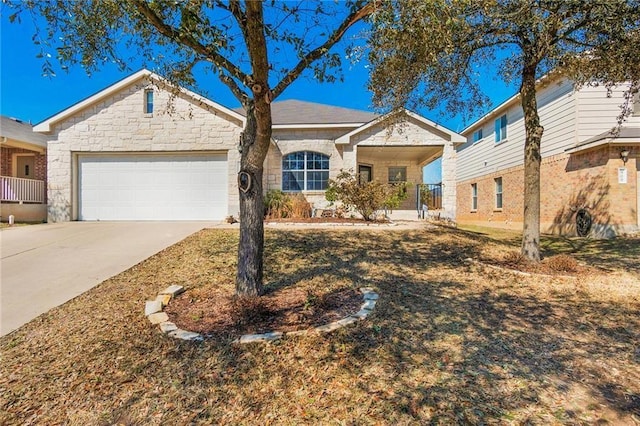 913 Cindy Ln, Leander, TX 78641 - single story home with an attached garage, driveway, covered porch, and stone siding