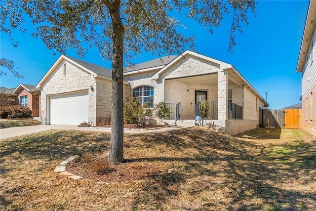 913 Cindy Ln, Leander, TX 78641 - single story home with an attached garage, stone siding, concrete driveway, and a porch