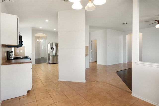 913 Cindy Ln, Leander, TX 78641 - kitchen with stainless steel fridge, a chandelier, light tile patterned flooring, stove, and recessed lighting