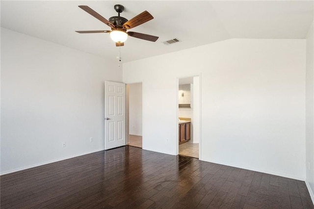 913 Cindy Ln, Leander, TX 78641 - spare room featuring wood finished floors, ceiling fan, vaulted ceiling, and baseboards