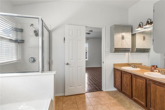 913 Cindy Ln, Leander, TX 78641 - bathroom with a shower stall, healthy amount of natural light, tile patterned floors, and a bath