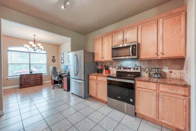 121 Cedar St, Granite Shoals, TX 78654 - kitchen with appliances with stainless steel finishes, light brown cabinets, baseboards, and tasteful backsplash