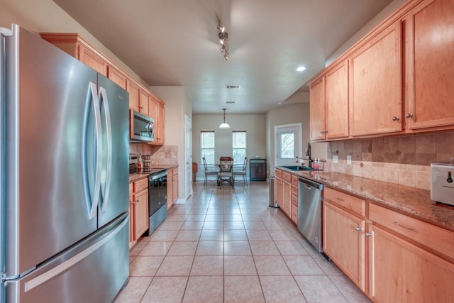 121 Cedar St, Granite Shoals, TX 78654 - kitchen with stainless steel appliances, light brown cabinets, a sink, tasteful backsplash, and light tile patterned floors