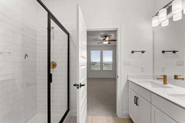 16917 Santiaguillo Trce, Manor, TX 78653 - bathroom with a stall shower, ceiling fan, and double vanity