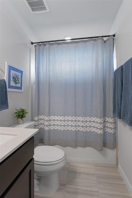 8212 Daisy Cutter Xing, Georgetown, TX 78626 - bathroom featuring toilet, shower / tub combo with curtain, vanity, and tile patterned flooring