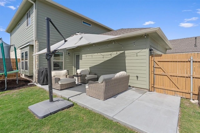 8212 Daisy Cutter Xing, Georgetown, TX 78626 - rear view of house with a trampoline, a patio area, an outdoor hangout area, and a gate