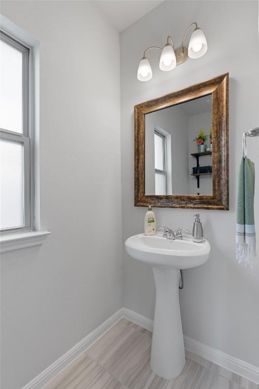 8212 Daisy Cutter Xing, Georgetown, TX 78626 - bathroom with baseboards, healthy amount of natural light, and a sink