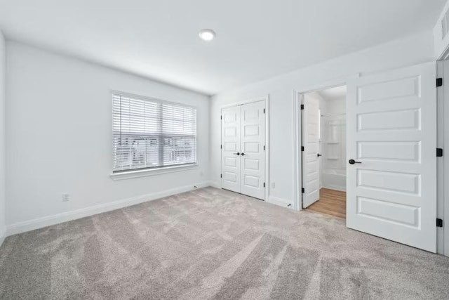 16921 Santiaguillo Trce, Manor, TX 78653 - unfurnished bedroom with carpet flooring, baseboards, connected bathroom, and a closet
