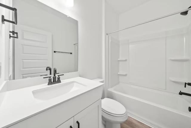 16921 Santiaguillo Trce, Manor, TX 78653 - bathroom featuring toilet, vanity, wood finished floors, and shower / bathtub combination