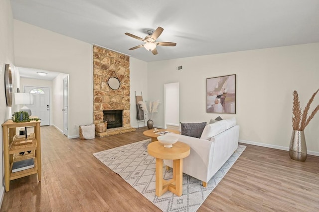 12214 Scribe Dr, Austin, TX 78759 - living area with a ceiling fan, light wood-style floors, baseboards, and a fireplace